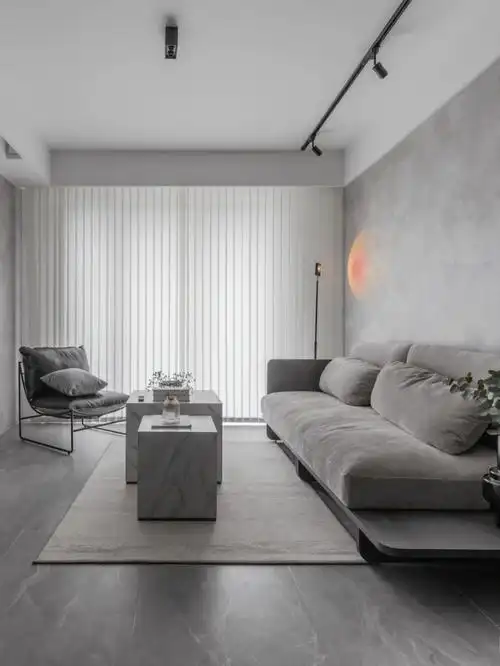 大气而又优雅;水泥艺术漆涂抹墙面,一组深灰色沙发,落日灯营造绝美的