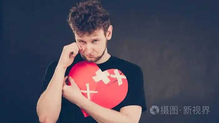 心碎的概念不幸的悲伤男人抱着粘在爱的标志符号上人的感觉被石膏所