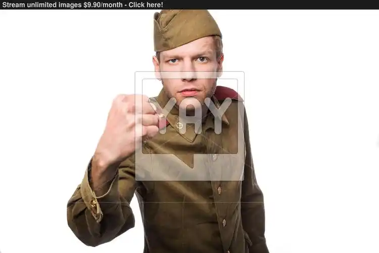 angry russian soldier threaten with a fist