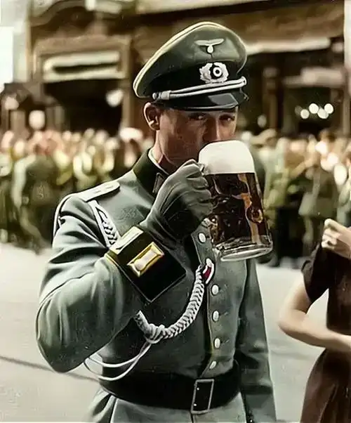 二战期间举杯畅饮的德国军官穿制式礼服在街头豪迈地喝着啤酒