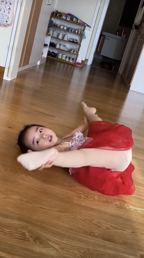 视频中,小酒窝身穿小红裙,展现各种舞蹈动作,下腰劈叉优雅范儿十足.