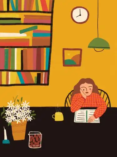 温暖的书房里女孩在书桌前托腮静静地看书